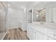 This bright bathroom has double sinks, quartz countertops, and a tiled shower at 902 Westminster Dr, Statesville, NC 28677
