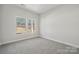 Bright bedroom with carpeted floor, two windows, and fresh paint at 902 Westminster Dr, Statesville, NC 28677