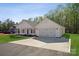 Side view of a modern single-story home showcasing its attached garage and well-maintained landscaping at 902 Westminster Dr, Statesville, NC 28677