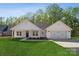 Charming single-story home featuring a well-manicured lawn, attached garage, and inviting covered porch at 902 Westminster Dr, Statesville, NC 28677