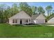 Attractive single-story residence featuring a green lawn, attached garage, and welcoming front porch at 902 Westminster Dr, Statesville, NC 28677