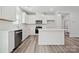 Bright kitchen with stainless steel appliances, white cabinets, and kitchen island with room for seating at 902 Westminster Dr, Statesville, NC 28677