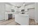 Bright, modern kitchen features white cabinets, stainless steel appliances, and an island with pendant lighting at 902 Westminster Dr, Statesville, NC 28677