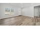 Bright living room features windows, modern flooring, a front door, and neutral walls at 902 Westminster Dr, Statesville, NC 28677