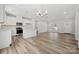 Open concept living area with kitchen, dining area, and stainless appliances, and vinyl floors at 902 Westminster Dr, Statesville, NC 28677
