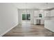 Modern living space with sleek floors, leading to a dining area, stainless steel appliances, and a backyard view at 902 Westminster Dr, Statesville, NC 28677