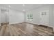 Inviting living area featuring sleek floors, natural light from the front door and windows, and neutral walls at 902 Westminster Dr, Statesville, NC 28677