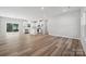 Bright, open-concept living area with modern floors, seamlessly blending into a stylish kitchen and dining space at 902 Westminster Dr, Statesville, NC 28677