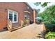 Brick patio, garden, lush landscaping and seating, perfect for outdoor enjoyment and relaxation at 10625 Olde Irongate Ln, Mint Hill, NC 28227