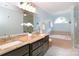Bathroom features a double vanity, soaking tub, and elegant fixtures for a spa-like experience at 10625 Olde Irongate Ln, Mint Hill, NC 28227