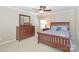 Inviting bedroom showcasing a dresser, mirror, ceiling fan, and comfortable furnishings at 10625 Olde Irongate Ln, Mint Hill, NC 28227