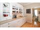 Convenient butler pantry featuring ample counter space, storage cabinets, and hardwood floors at 10625 Olde Irongate Ln, Mint Hill, NC 28227