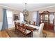Elegant dining room with a large table, chandelier, and traditional decor, ideal for gatherings at 10625 Olde Irongate Ln, Mint Hill, NC 28227