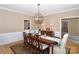 Spacious dining area featuring a large table, chandelier, and access to other areas of the home at 10625 Olde Irongate Ln, Mint Hill, NC 28227