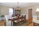 Refined dining room featuring a large table, sophisticated decor, and hardwood floors at 10625 Olde Irongate Ln, Mint Hill, NC 28227