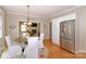 Eat in kitchen features stainless steel appliances, wood flooring, and an open view into the living room at 10625 Olde Irongate Ln, Mint Hill, NC 28227