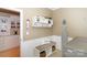 A tidy laundry room offers storage space, and a convenient bench and coat rack for added functionality at 10625 Olde Irongate Ln, Mint Hill, NC 28227