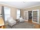 Cozy living room featuring hardwood floors, neutral paint, and french doors at 10625 Olde Irongate Ln, Mint Hill, NC 28227