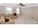 Comfortable living room with a neutral color scheme, plush sectional sofa and ample natural light at 10625 Olde Irongate Ln, Mint Hill, NC 28227