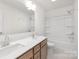 Bright bathroom featuring double sinks, modern fixtures, and a tub with shower, combining functionality and style at 11032 Gary Player Dr # 961, Lancaster, SC 29720