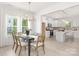 Bright dining room with a large table and modern chandelier, located adjacent to an open kitchen at 11032 Gary Player Dr # 961, Lancaster, SC 29720