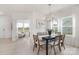 Elegant dining room with modern chandelier and windows offering natural light, adjacent to living area at 11032 Gary Player Dr # 961, Lancaster, SC 29720
