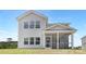 Light gray home featuring a screened-in porch and bright windows on a sunny day at 11032 Gary Player Dr # 961, Lancaster, SC 29720