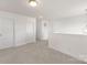 Bright hallway features neutral carpeting, white walls, and multiple doors, offering a clean and spacious feel at 11032 Gary Player Dr # 961, Lancaster, SC 29720