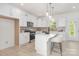 Bright kitchen featuring white cabinets, stainless steel appliances, and a stylish island with seating at 11032 Gary Player Dr # 961, Lancaster, SC 29720