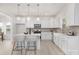 Contemporary kitchen featuring white cabinets, stainless steel appliances, and a center island with bar stools at 11032 Gary Player Dr # 961, Lancaster, SC 29720