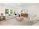 Bright living room with modern decor, large windows, and comfortable seating arrangement at 11032 Gary Player Dr # 961, Lancaster, SC 29720