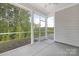 Covered and screened porch with ample space, offering a serene outdoor living area overlooking a lush, private backyard at 11032 Gary Player Dr # 961, Lancaster, SC 29720