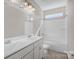Bright bathroom featuring a double sink vanity and a shower-tub combo with modern fixtures at 111 Bell Chase Ln, Statesville, NC 28677