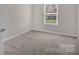 Bedroom with neutral walls and carpet flooring, showcasing natural light through the window at 111 Bell Chase Ln, Statesville, NC 28677