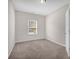 Sunny bedroom with plush carpet, and a large window offering natural light and neighborhood views at 111 Bell Chase Ln, Statesville, NC 28677