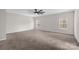 Spacious bedroom with plush carpeting, ceiling fan, and natural light from two windows at 111 Bell Chase Ln, Statesville, NC 28677