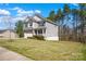 Well-maintained two-story home with a spacious yard, mature trees, and attractive landscaping at 111 Bell Chase Ln, Statesville, NC 28677