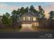 Charming two-story home with stone and siding exterior, a well-manicured front yard, and an attached two-car garage at 111 Bell Chase Ln, Statesville, NC 28677