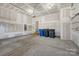 Unfinished two car garage with painted walls and bare concrete floor at 111 Bell Chase Ln, Statesville, NC 28677