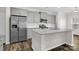 Kitchen with gray cabinets, stainless steel refrigerator, subway tile backsplash at 111 Bell Chase Ln, Statesville, NC 28677