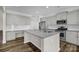 Spacious kitchen with gray cabinets, stainless steel appliances, island and granite countertops at 111 Bell Chase Ln, Statesville, NC 28677