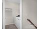 Convenient laundry room featuring tile flooring, washer, dryer, and built-in shelving at 111 Bell Chase Ln, Statesville, NC 28677
