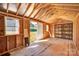 Inside a new shed with open stud walls, wood floors, a shelving unit and natural light at 111 Bell Chase Ln, Statesville, NC 28677