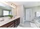 Bright bathroom featuring double sinks, granite countertops, and a large mirror at 116 Dublin Ct, Statesville, NC 28677