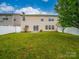 The back yard features a well-maintained lawn, privacy fence, and view of the home's rear elevation at 118 Glade Valley Ave, Mooresville, NC 28117