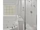 Bright bathroom featuring a large tub and a shower at 118 Glade Valley Ave, Mooresville, NC 28117