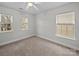 Bright bedroom with neutral carpet, windows, and ceiling fan at 118 Glade Valley Ave, Mooresville, NC 28117