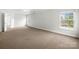 Spacious carpeted bedroom filled with natural light from the windows at 118 Glade Valley Ave, Mooresville, NC 28117