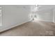 Bright bedroom with neutral carpet, windows, and ceiling fan at 118 Glade Valley Ave, Mooresville, NC 28117