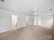 Large bonus room with neutral carpet, ceiling fan, and multiple doorways at 118 Glade Valley Ave, Mooresville, NC 28117